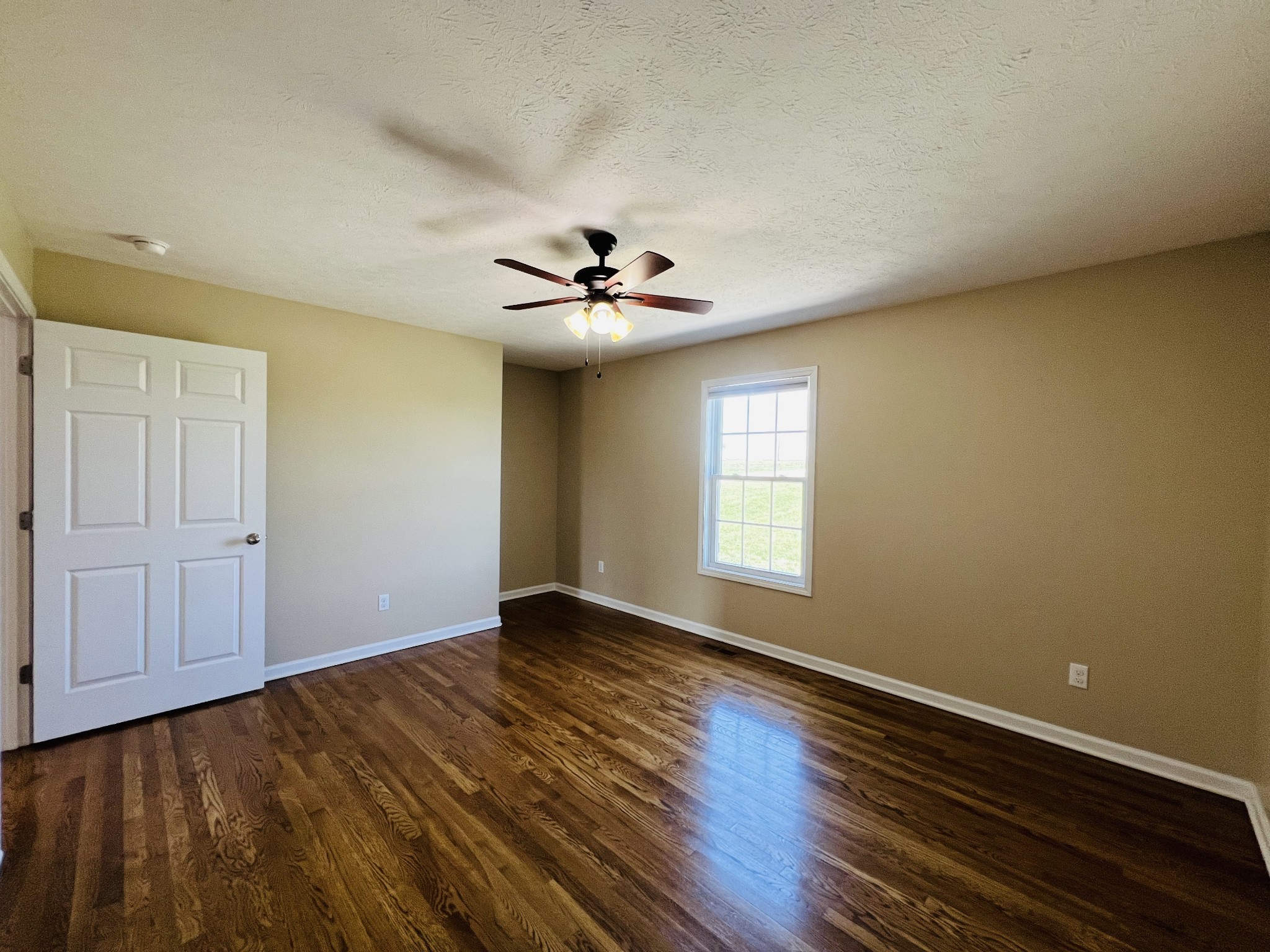 663 Jackson Road Portland, TN 37148 - Photo 25 of 32 a view of an empty room with a window and wooden floor