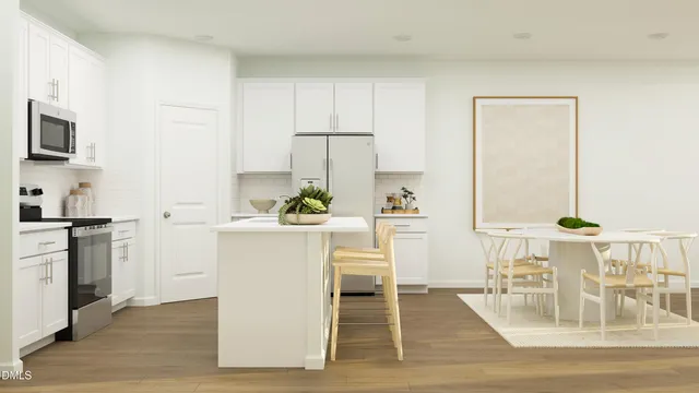 a kitchen with white cabinets and black appliances