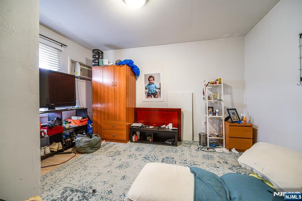 390 Lafayette Street Newark, NJ 07105 - Photo 19 of 40 a bedroom with furniture and a flat screen tv
