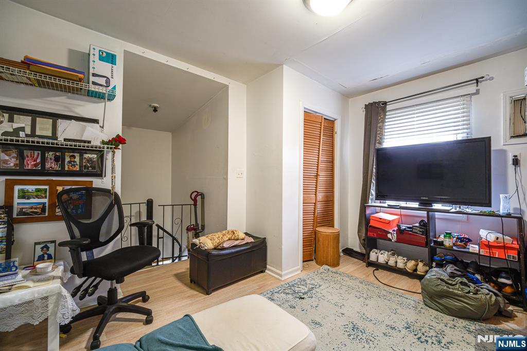 390 Lafayette Street Newark, NJ 07105 - Photo 20 of 40 a living room with furniture and a flat screen tv