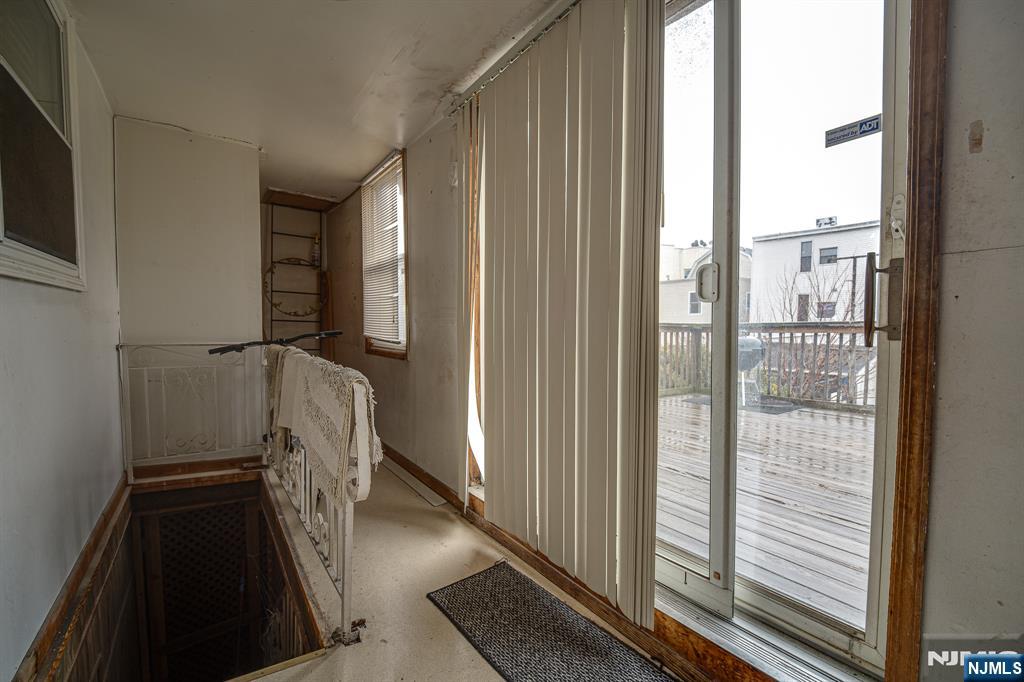 390 Lafayette Street Newark, NJ 07105 - Photo 23 of 40 a view of a hallway with wooden floor and staircase