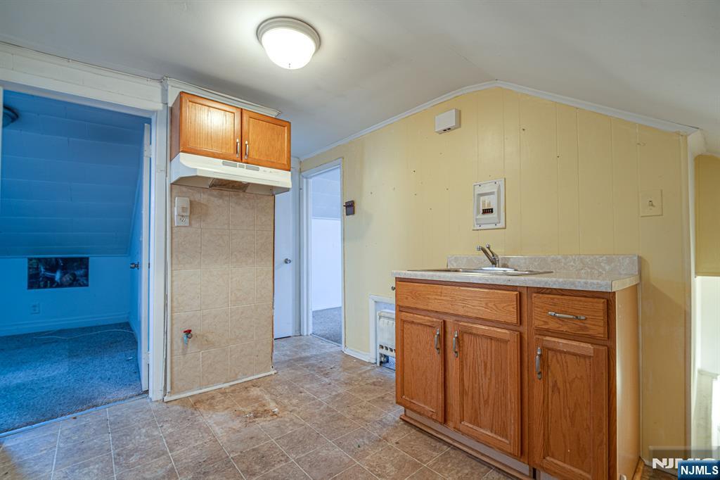390 Lafayette Street Newark, NJ 07105 - Photo 27 of 40 a bathroom with a sink a mirror and shower
