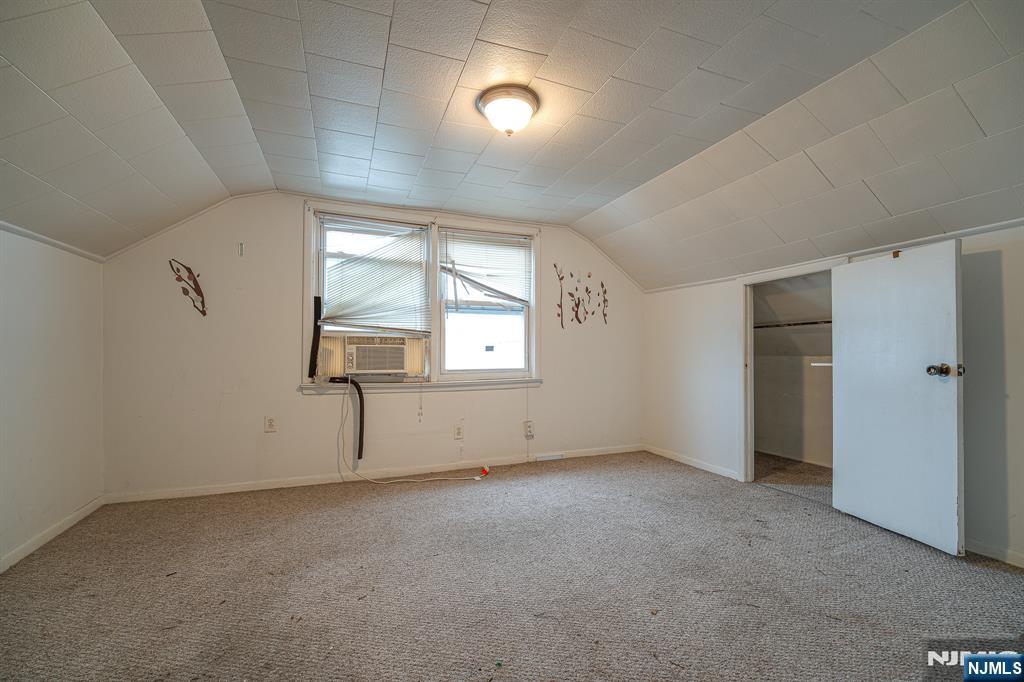 390 Lafayette Street Newark, NJ 07105 - Photo 28 of 40 an empty room with windows and cabinet