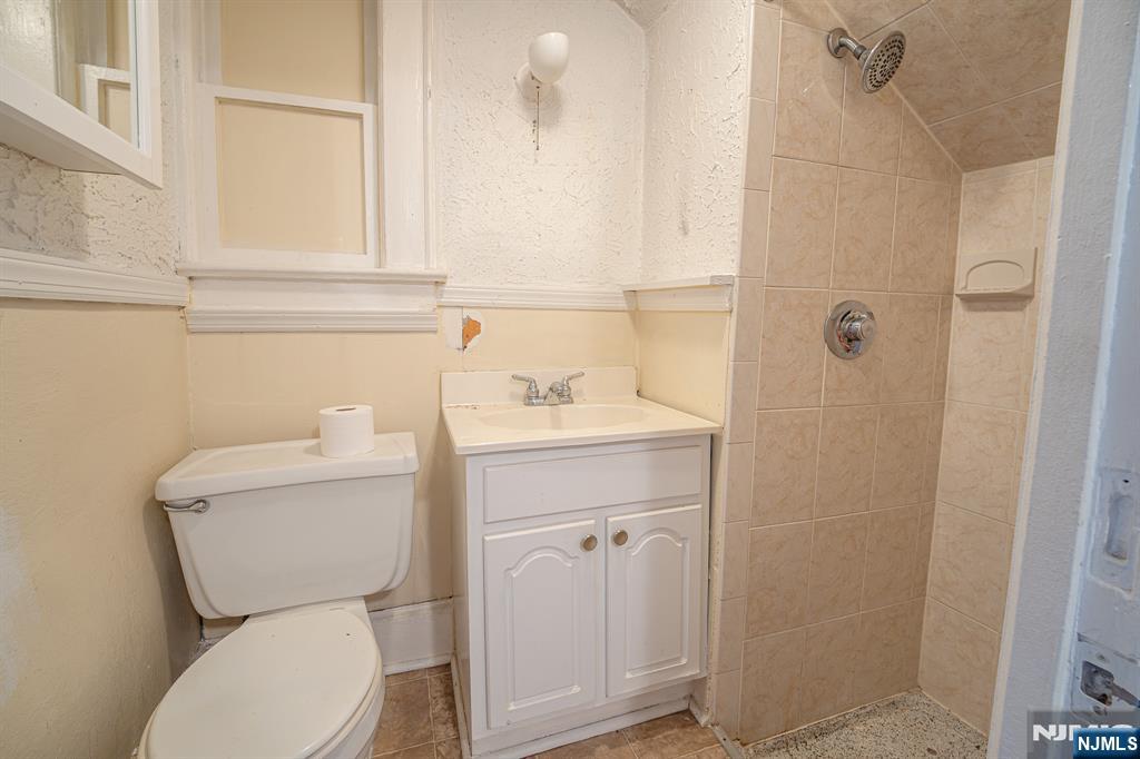 390 Lafayette Street Newark, NJ 07105 - Photo 31 of 40 a bathroom with a sink a toilet and shower