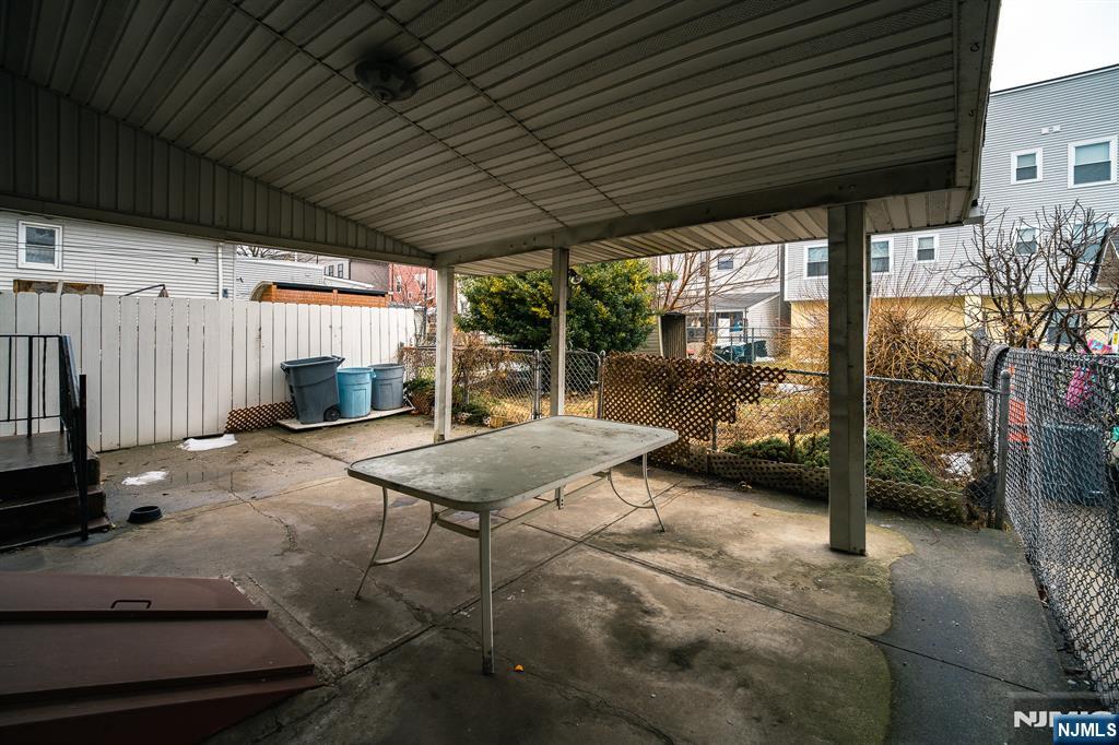 390 Lafayette Street Newark, NJ 07105 - Photo 37 of 40 a backyard of a house with barbeque oven table and chairs
