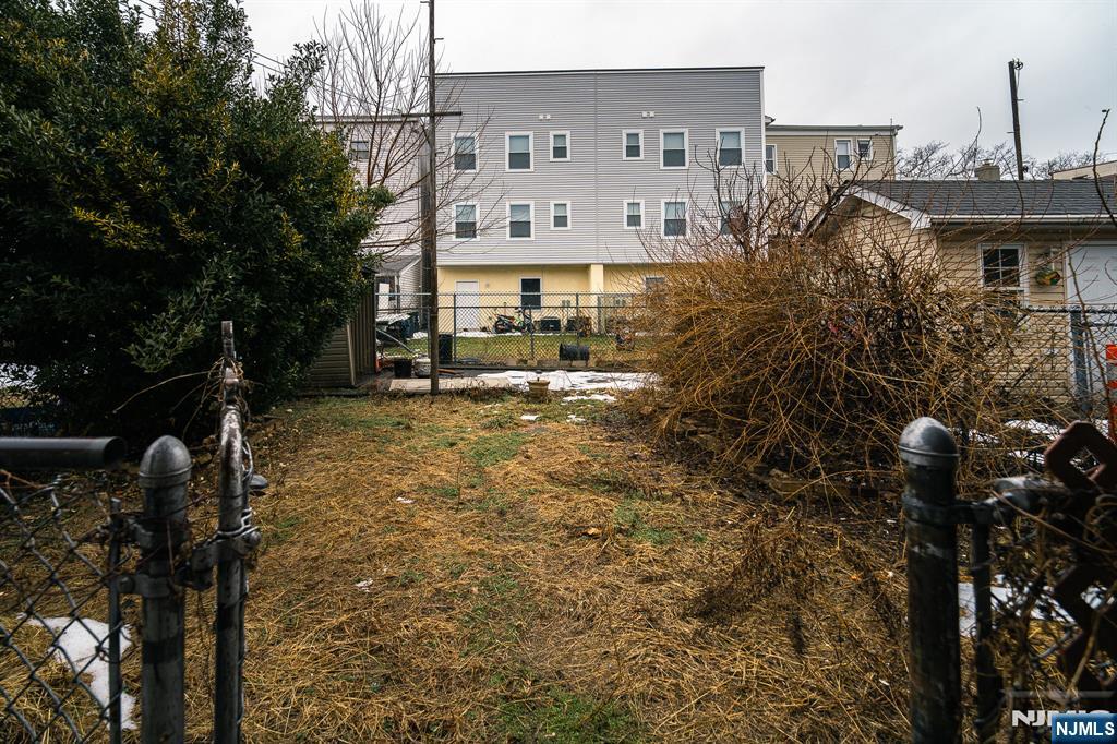 390 Lafayette Street Newark, NJ 07105 - Photo 39 of 40 a front view of a house with a yard