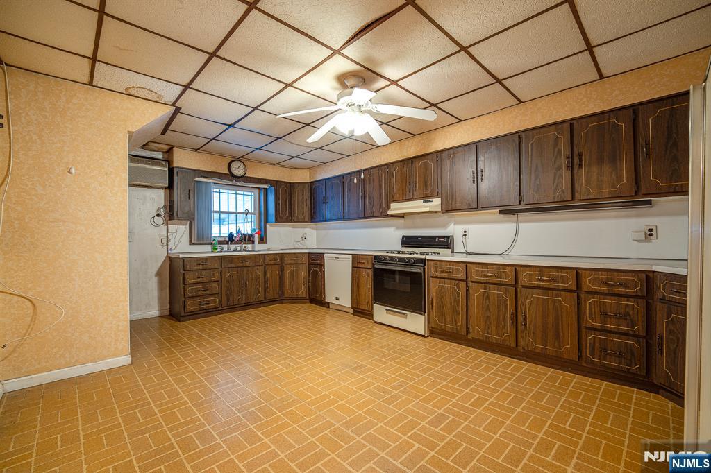 390 Lafayette Street Newark, NJ 07105 - Photo 9 of 40 a kitchen with stainless steel appliances granite countertop a stove a sink dishwasher and a refrigerator