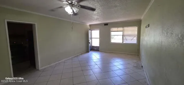 a view of an empty room with a window
