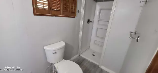 a white toilet sitting next to a bathroom sink