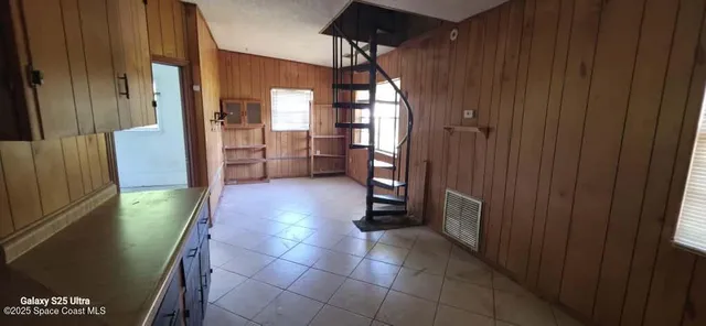 a bathroom with a glass door shower and a sink