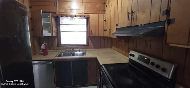 a kitchen with a sink stove and cabinets