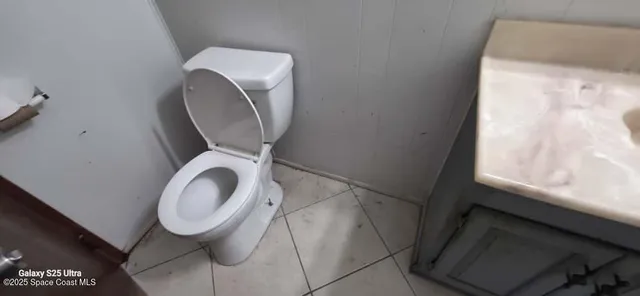 a bathroom with a toilet and a sink