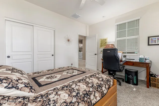 a bedroom with a bed and a desk