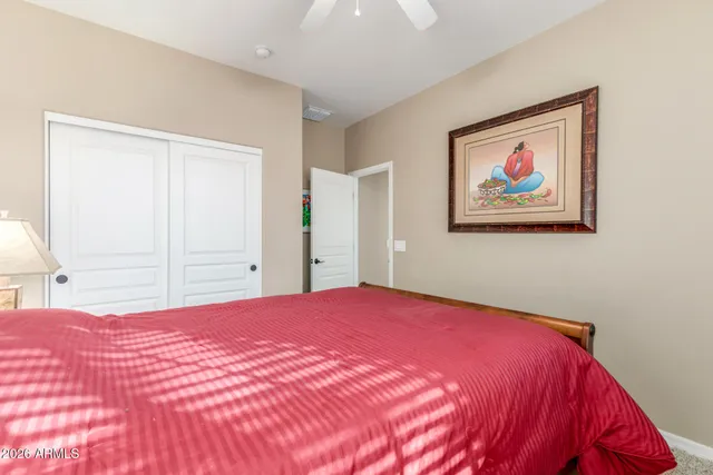 a bedroom with a bed and a painting on the wall