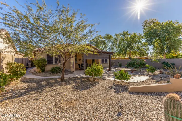 a view of a house with a tree in front