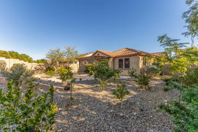 a view of a house with a yard and sitting area