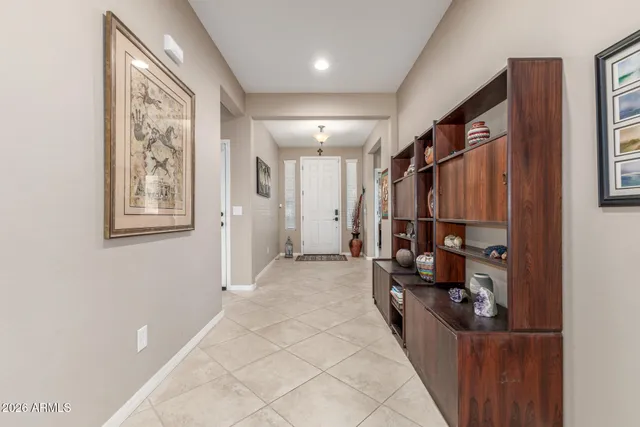 a view of a hallway with stairs and furniture