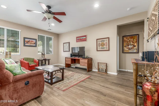 a living room with furniture and a wooden floor