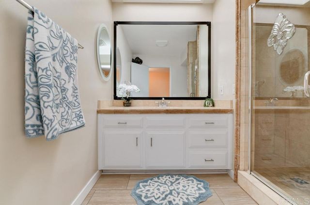 a bathroom with a mirror and a shower