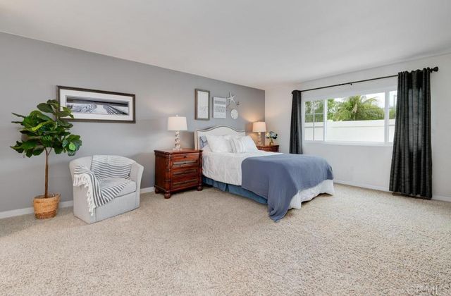 a spacious bedroom with a bed and a couch