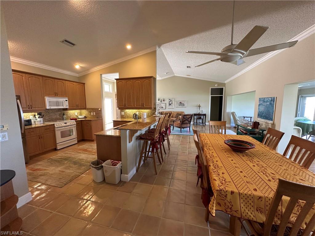 7159 Mill Pond Circle Naples, FL 34109 - Photo 11 of 27 a view of a dining room with furniture