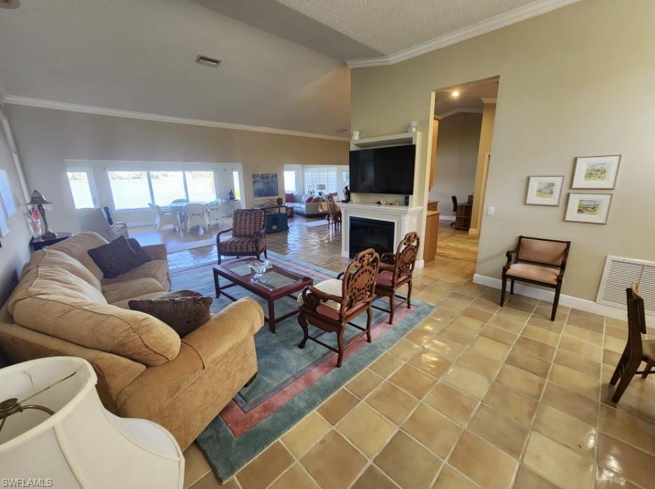 7159 Mill Pond Circle Naples, FL 34109 - Photo 19 of 27 a living room with fireplace furniture and a flat screen tv