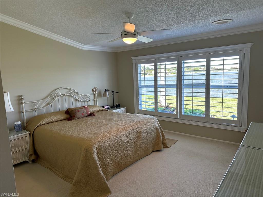 7159 Mill Pond Circle Naples, FL 34109 - Photo 3 of 27 a bedroom with a bed and window