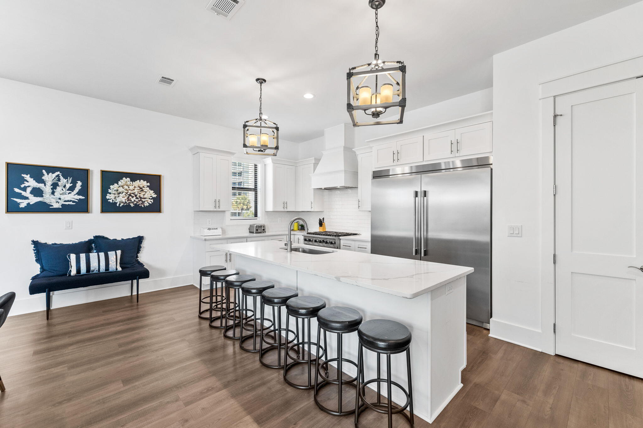 211 Snowdrift Road Miramar Beach, FL 32550 - Photo 12 of 46 a kitchen with stainless steel appliances kitchen island granite countertop a dining table chairs and a refrigerator