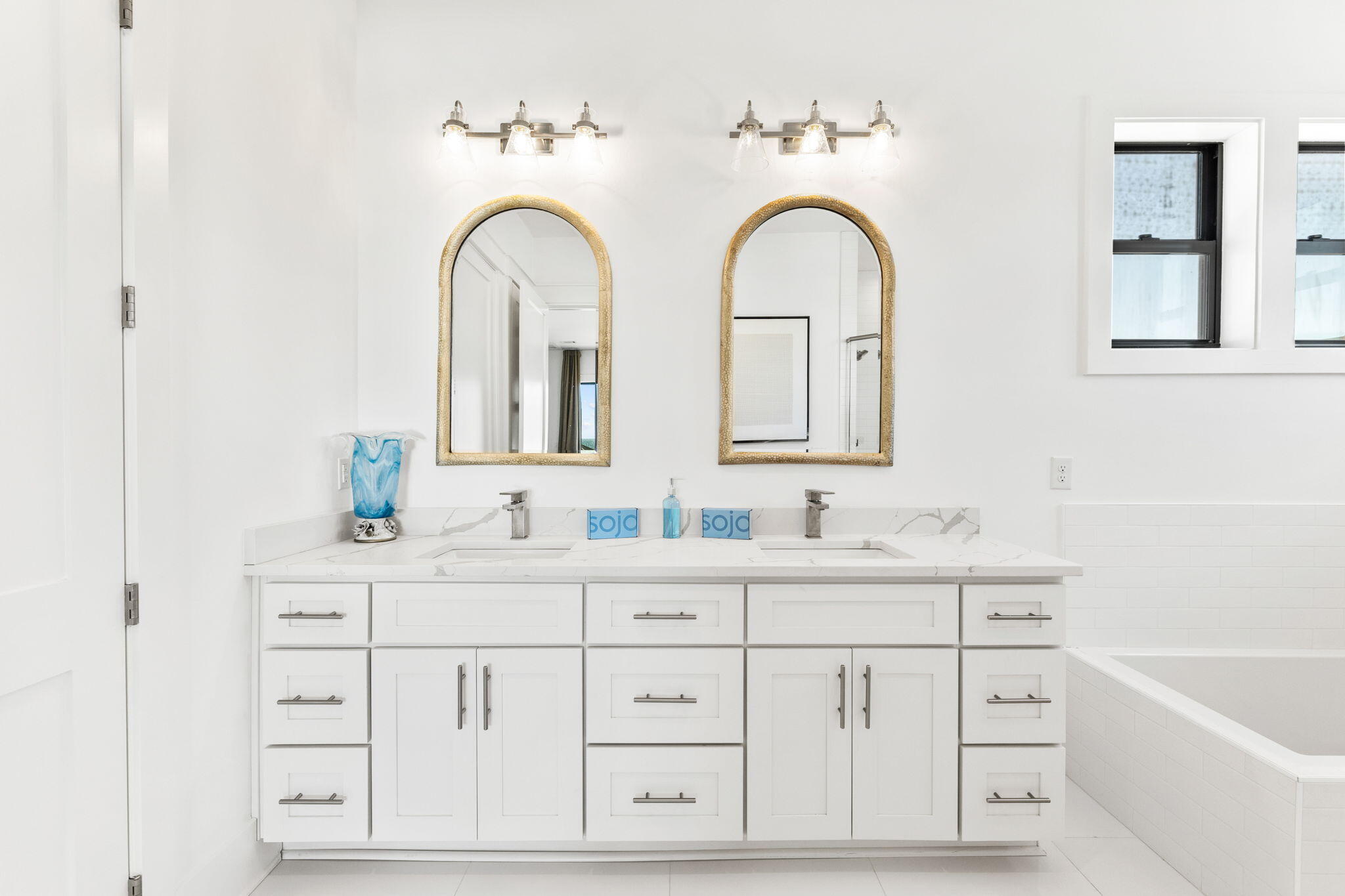 211 Snowdrift Road Miramar Beach, FL 32550 - Photo 17 of 46 a bathroom with a double vanity sink a bathtub and a window