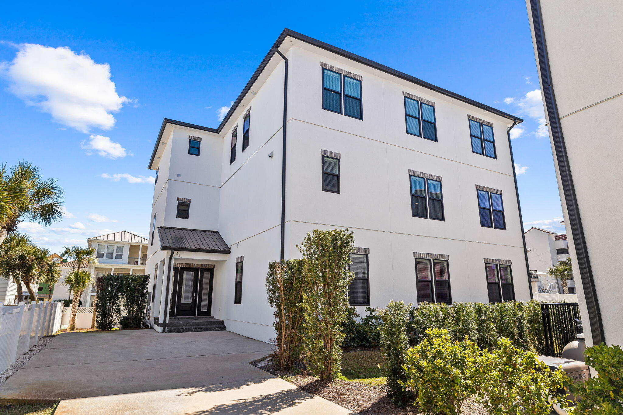 211 Snowdrift Road Miramar Beach, FL 32550 - Photo 43 of 46 a view of a white building among the street with palm trees
