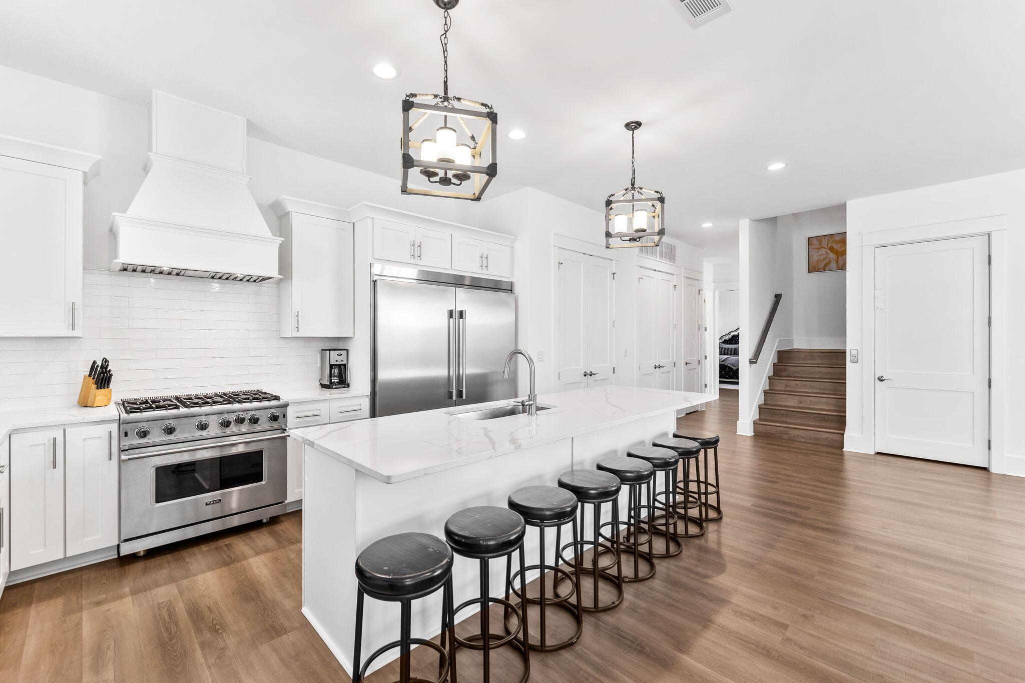 211 Snowdrift Road Miramar Beach, FL 32550 - Photo 8 of 46 a kitchen with granite countertop a dining table chairs stove and white cabinets