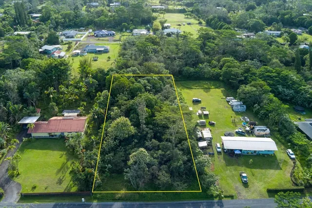 an aerial view of a house with a yard basket ball court and outdoor seating