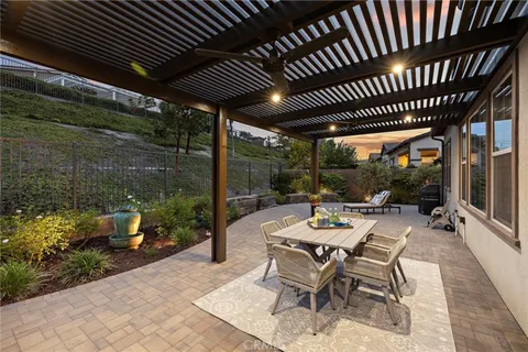 a view of a patio with table and chairs and potted plants
