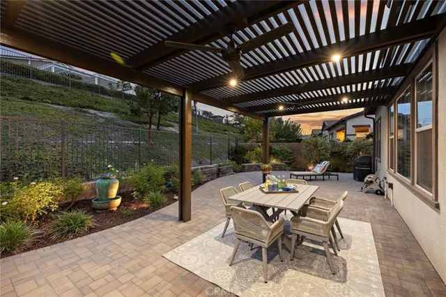 a view of a patio with table and chairs and potted plants