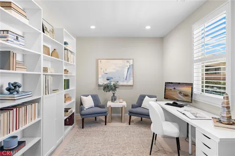 a living room with furniture a flat screen tv and a window