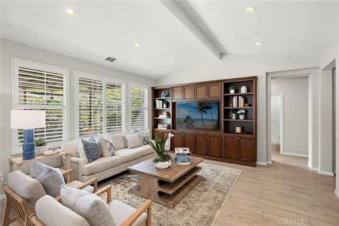 a living room with furniture and a large window with rug