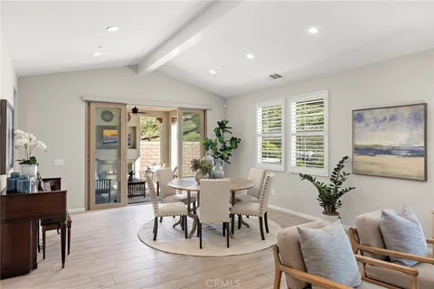 a dining room with furniture and wooden floor