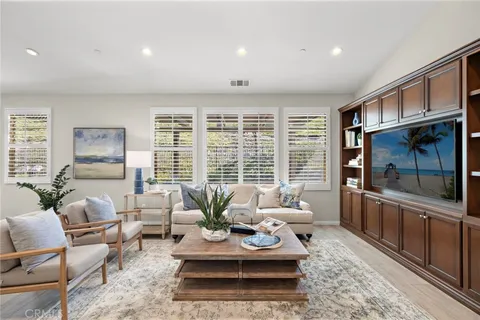 a living room with furniture large window and flat screen tv