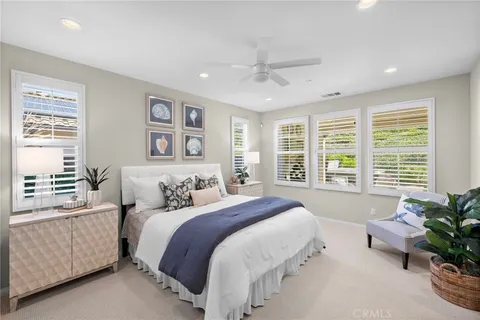 a spacious bedroom with a large bed and a large window