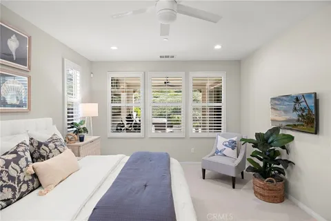 a spacious bedroom with a bed and a couch