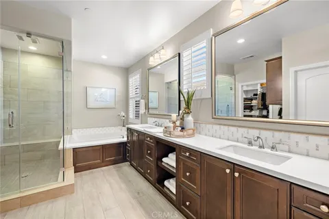 a spacious bathroom with a double vanity sink mirror and shower