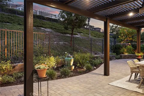 a view of a porch with chairs and backyard