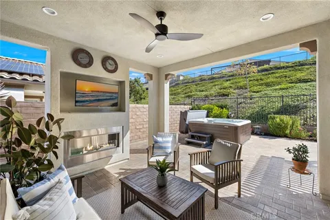 a living room with patio furniture and a floor to ceiling window
