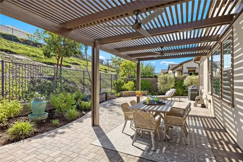 a view of a patio with table and chairs and potted plants