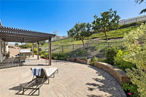 a view of a patio with table and chairs and potted plants
