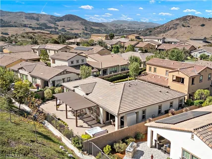 an aerial view of a house with a mountain