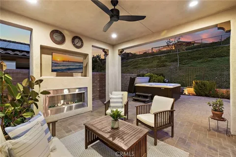 a outdoor space with patio couch and a fireplace