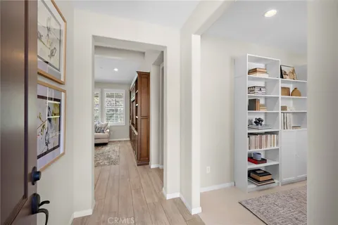 a hall way with furniture and wooden floor