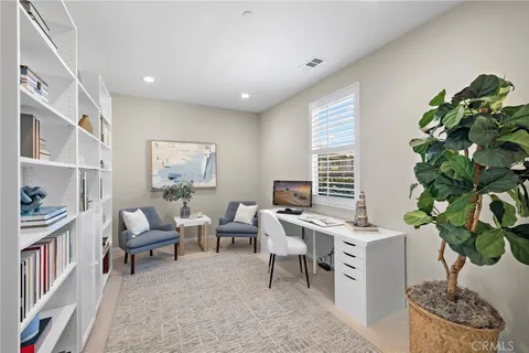 a workspace with furniture and a potted plant