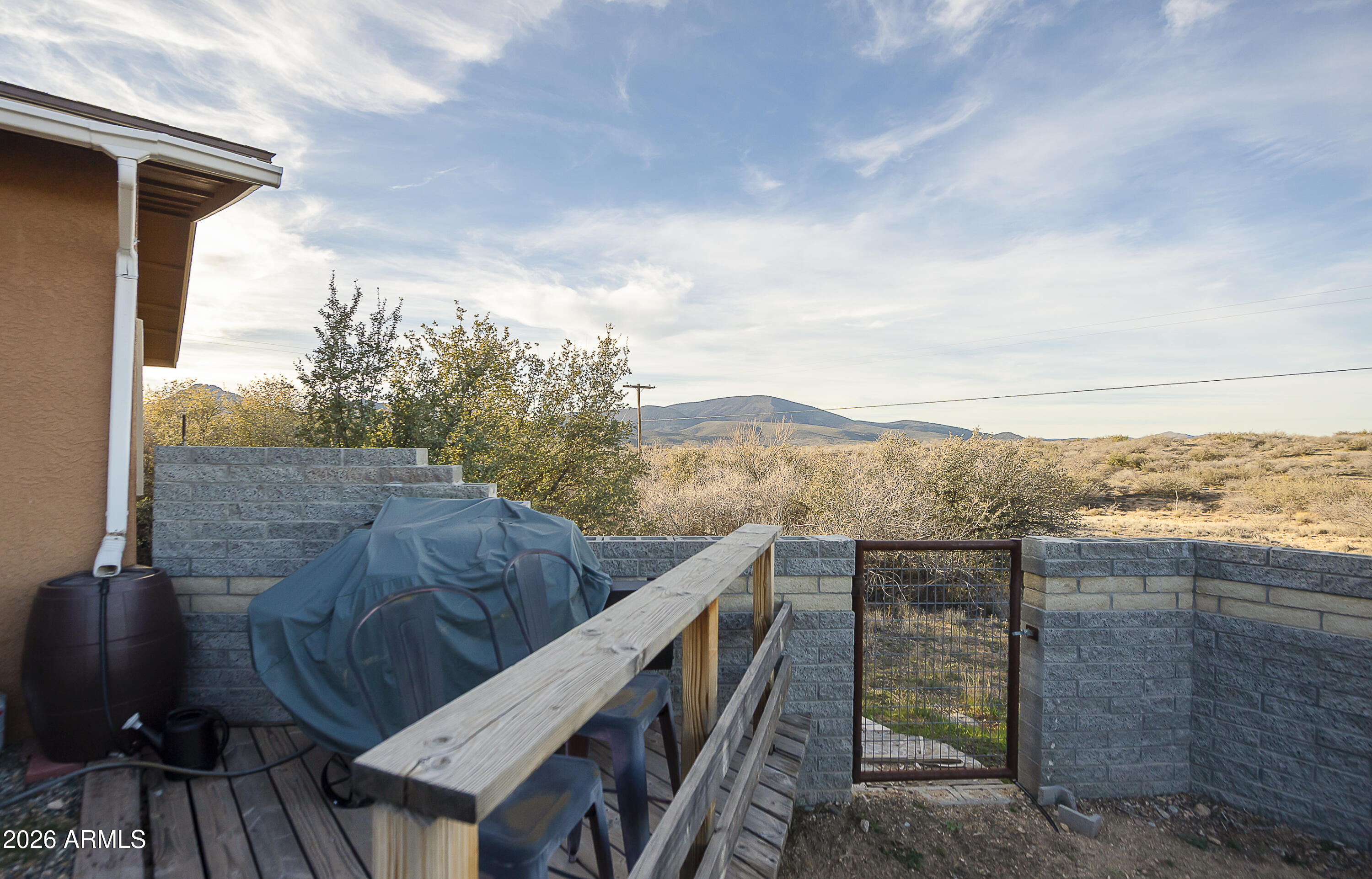 6565 Musgrove Road Skull Valley, AZ 86338 - Photo 45 of 67 a view of a balcony with chair and wooden fence